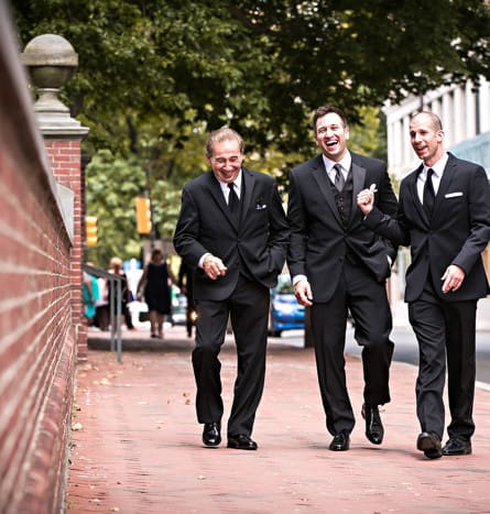 Groom with his father and groomsmen walking in philadelphia