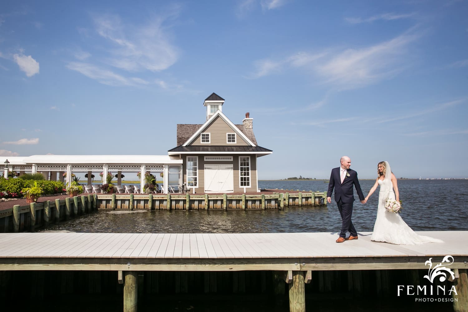 bride and groom walking on the dock at Mallard Island Yacht Club