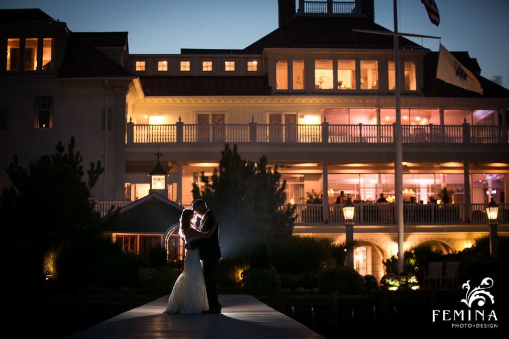 night photograph of bride and groom in front of Mallard Island Yacht Club