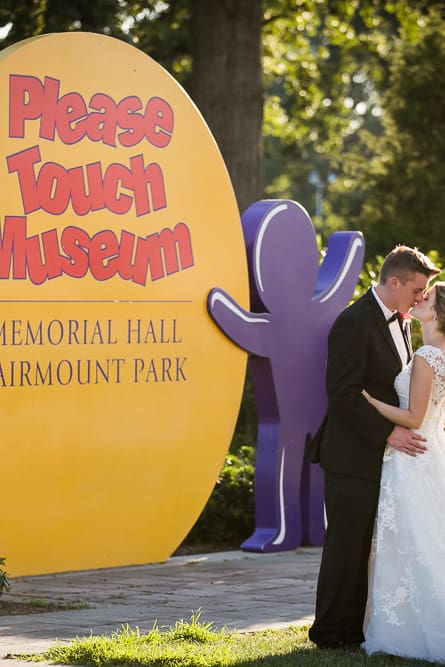 bride and groom portrait in front of the Please Touch Museum sign