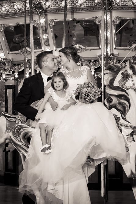 bride and groom posing on carousel at Please Touch Museum