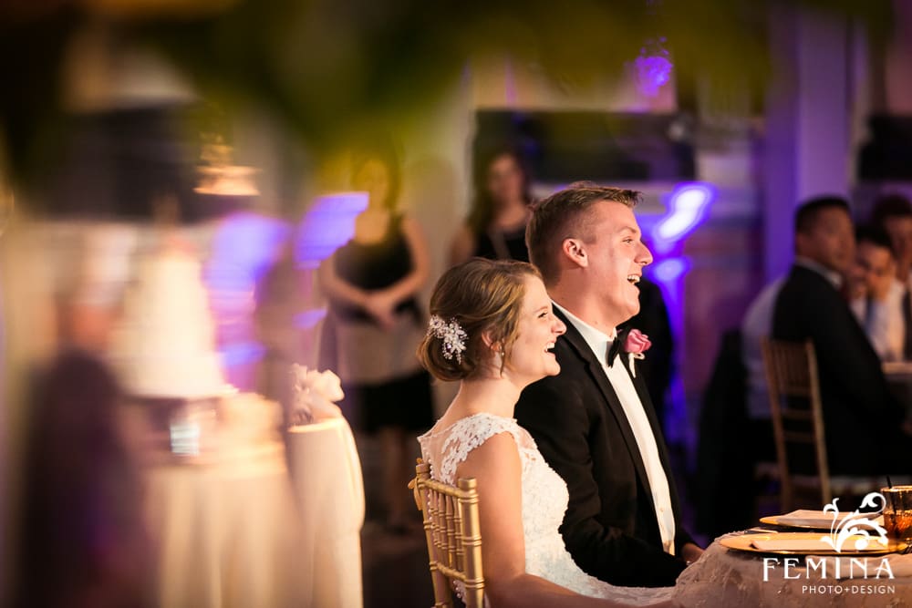 bride and groom laughing during speech