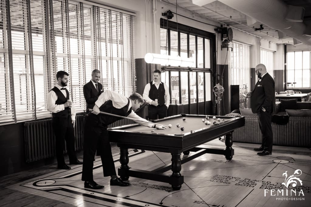 groomsmen playing a game of pool