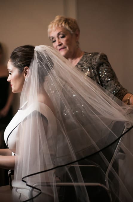 mother of the bride helping her with the veil