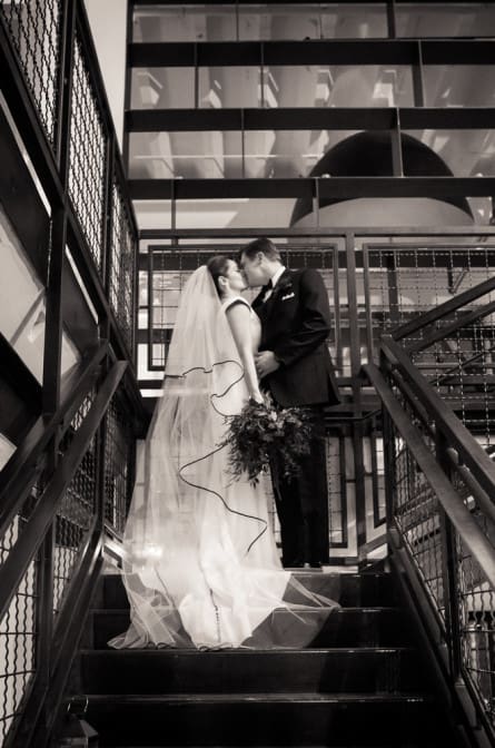 bride and groom posing on the stairs at Industry City Brooklyn