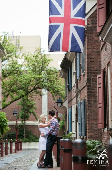 Rebecca and Lyall posing under a flag in Elfreth's Alley Philadelphia