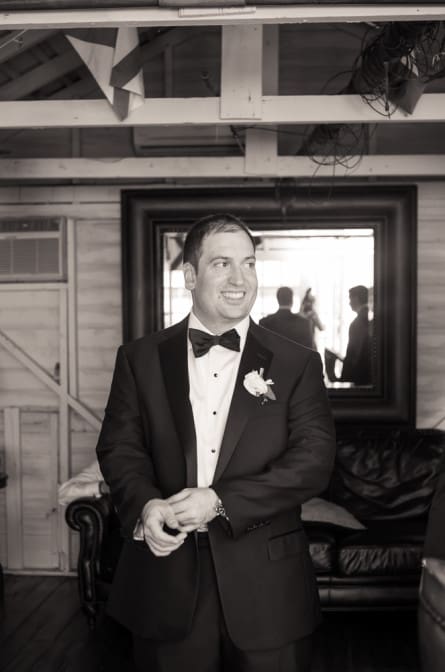 Matt getting ready in the groom's boathouse at Mallard Island Yacht Club