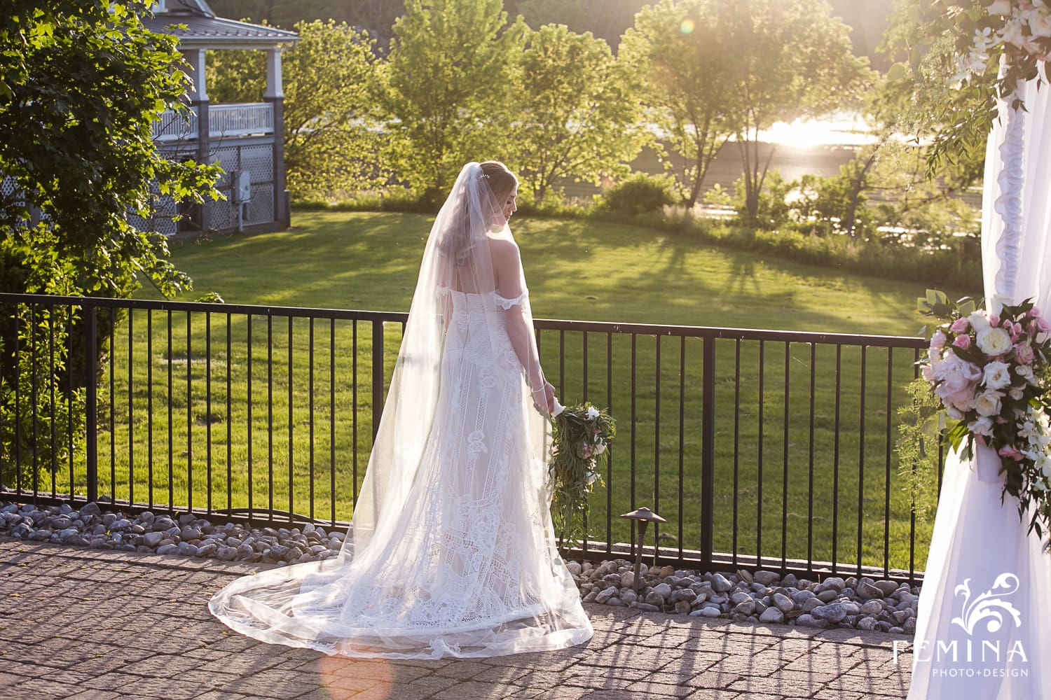 Kelli posing on the edge of the lake at her Lake House Inn Wedding