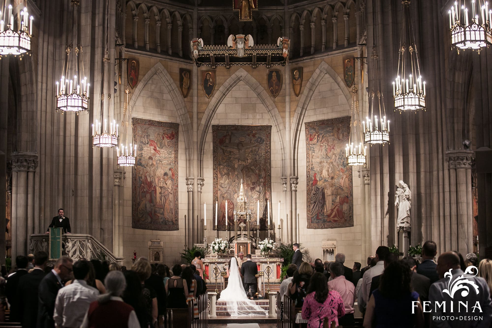 Ryan and Christina kneeling at the alter during their ceremony at Church of the Blessed Sacrament in NYC