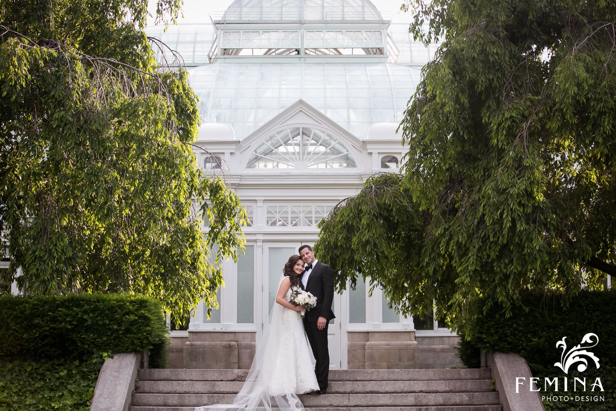 Ryan and Christina pose in front of the stairs of the atrium at NYBG