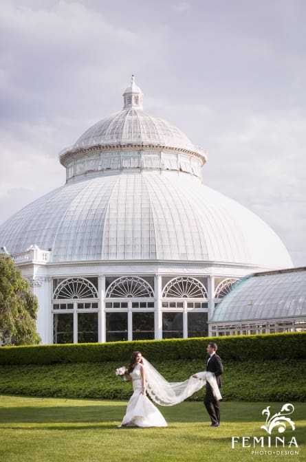 Christina and Ryan walking in front of the atrium at their NYBG wedding
