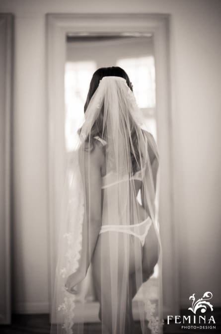 Photo of Eva looking in the mirror during a boudoir shoot by Philadelphia Boudoir Photographer