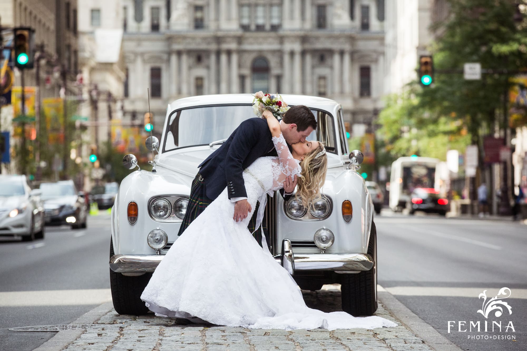 Lyall dips his bride Rebecca in front of City Hall on Broad St in Philadelphia
