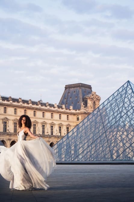 Model Alicia posing in front of the Louvre for a styled shoot