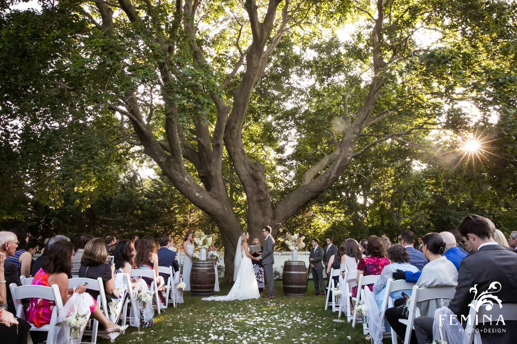 Lindsey and Tommy stand under the tree at Bedell Cellars during their ceremony