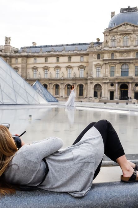 Bride Alicia poses in front of the Louvre for bridal portraits