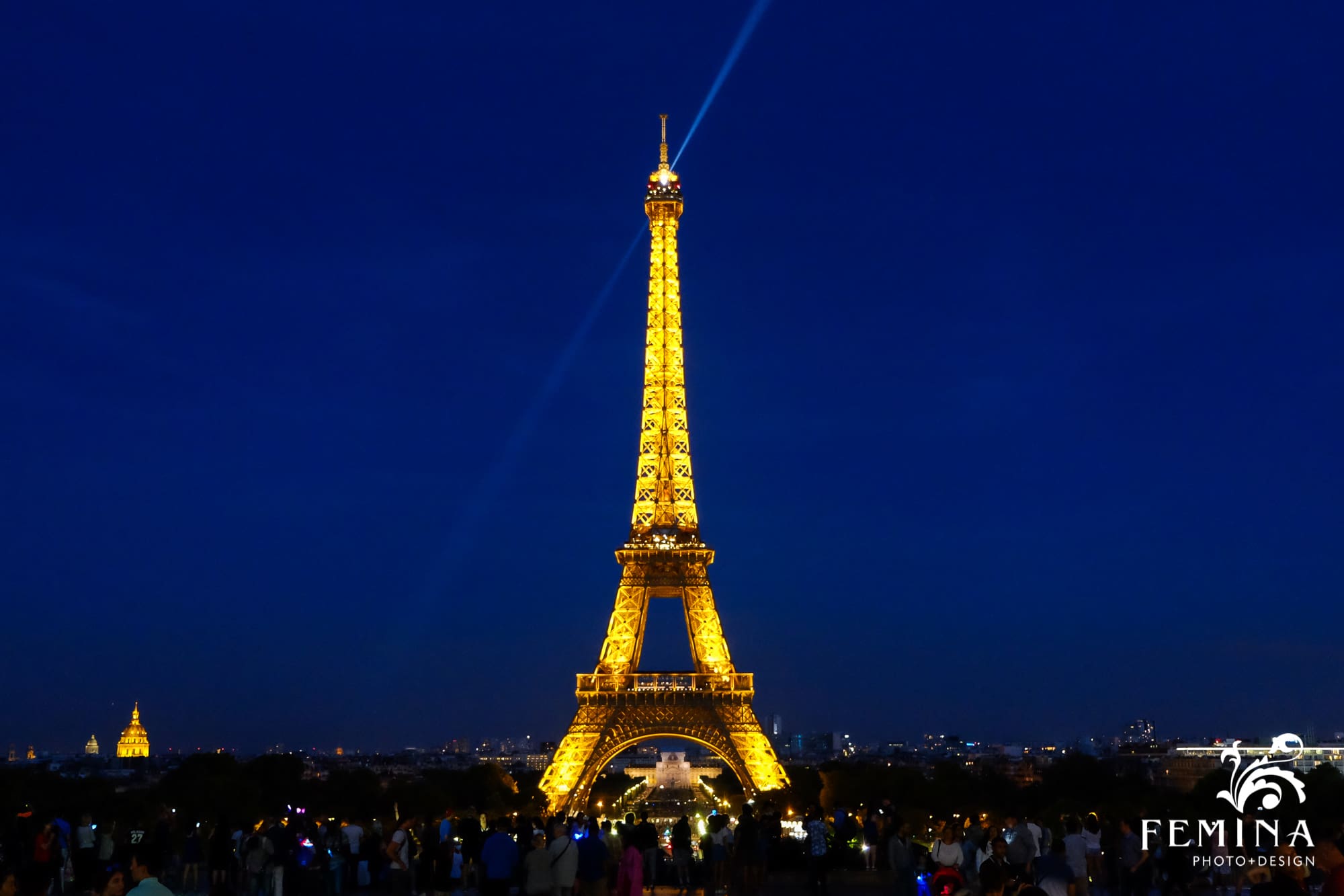 Eiffel Tower photographed at night with light beams