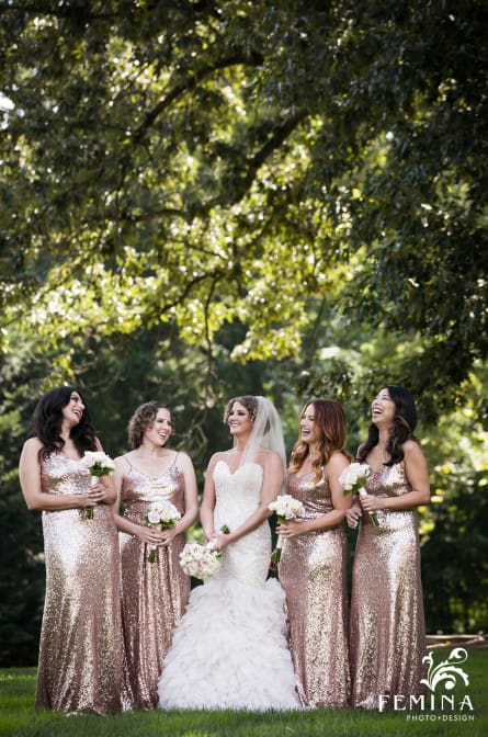 Michelle and her bridesmaids laughing under a tree at Saint Andrews School in Delaware