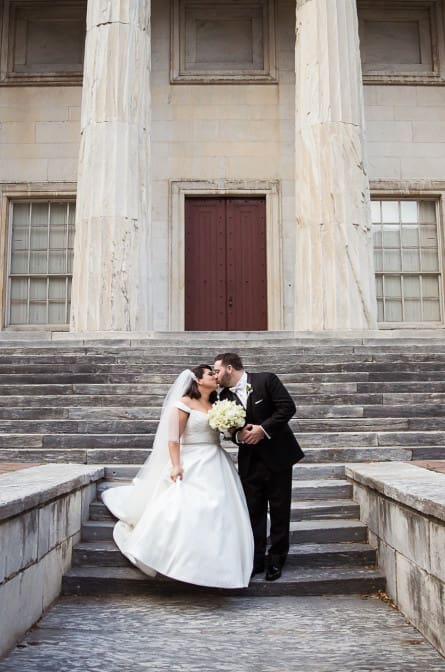 Christina and Matt kissing in front of the 2nd Bank before their wedding at the Bellevue
