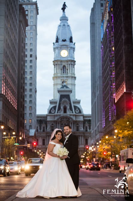 Christina and Matt pose on Broad Street in front of City Hall before their wedding
