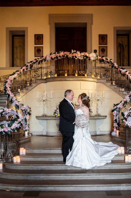 Bride and groom on the stairs of Oheka Castle