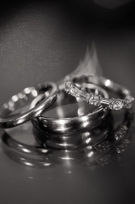 Wedding rings set upon a reflective table