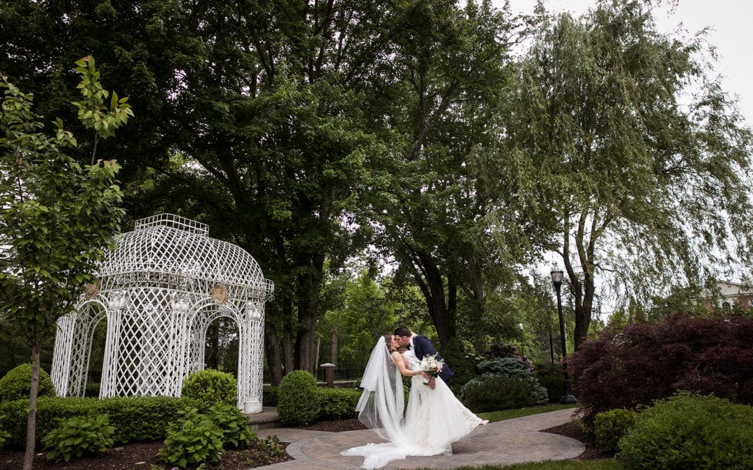 Bride and groom kissing in front of the gazebo at The Rockleigh