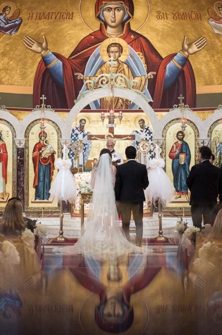 Chelsey and Alex standing at the altar during their Ceremony at Saint Barbara's Greek Orthodox Church