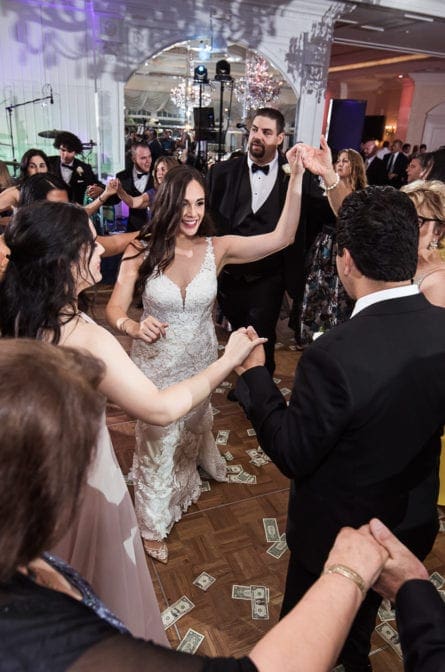 Bride and groom doing a traditional Greek dance at a wedding at Eagle Oaks Country Club