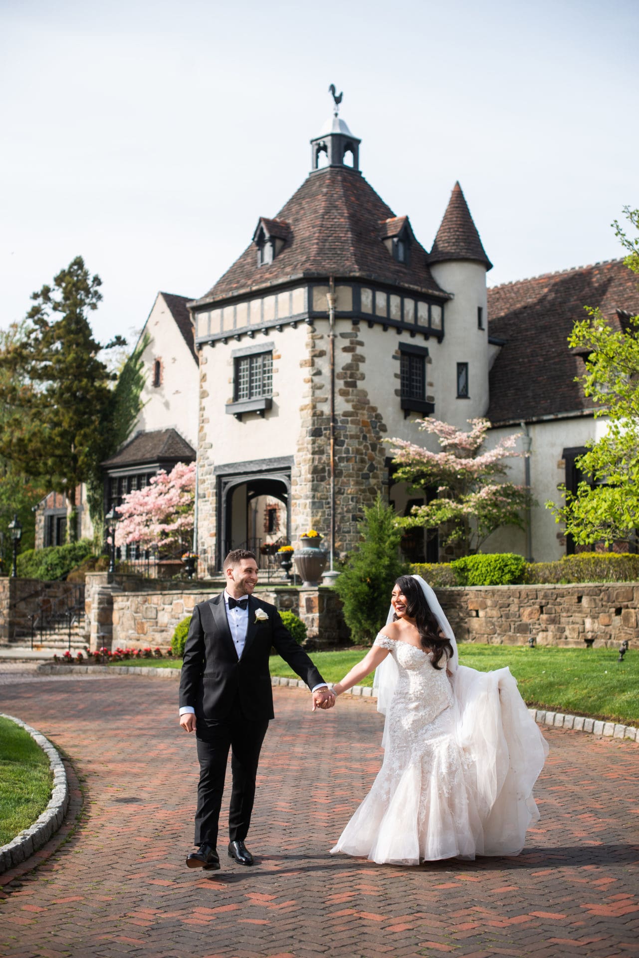 Bride and groom walking in front of the Pleasantdale Chateau