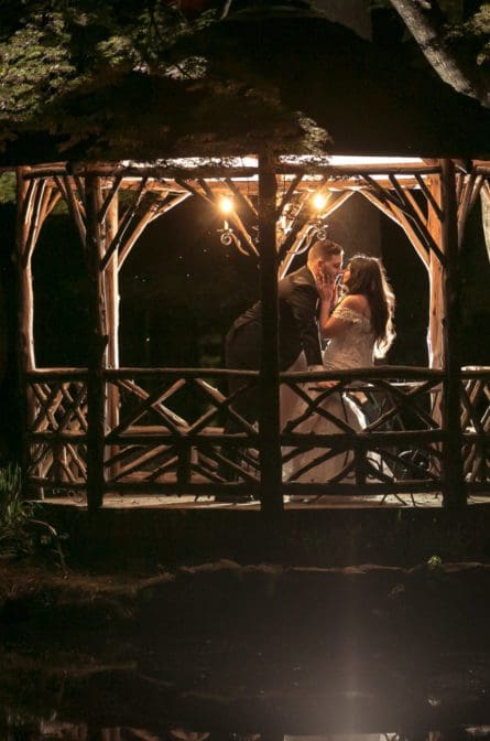 Bride and groom posing in the gazebo at Pleasantdale Chateau