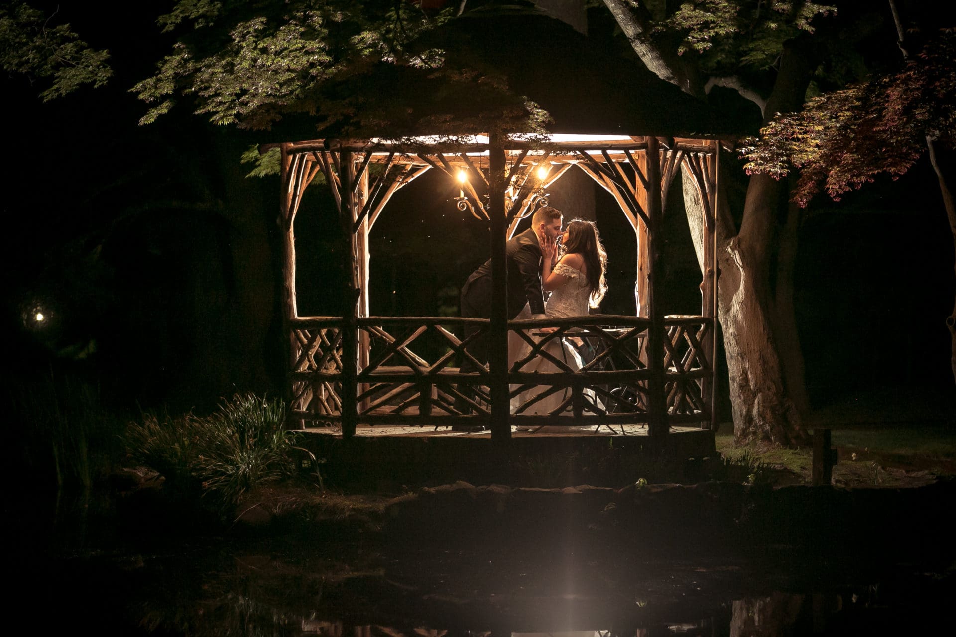 Bride and groom posing in the gazebo at Pleasantdale Chateau