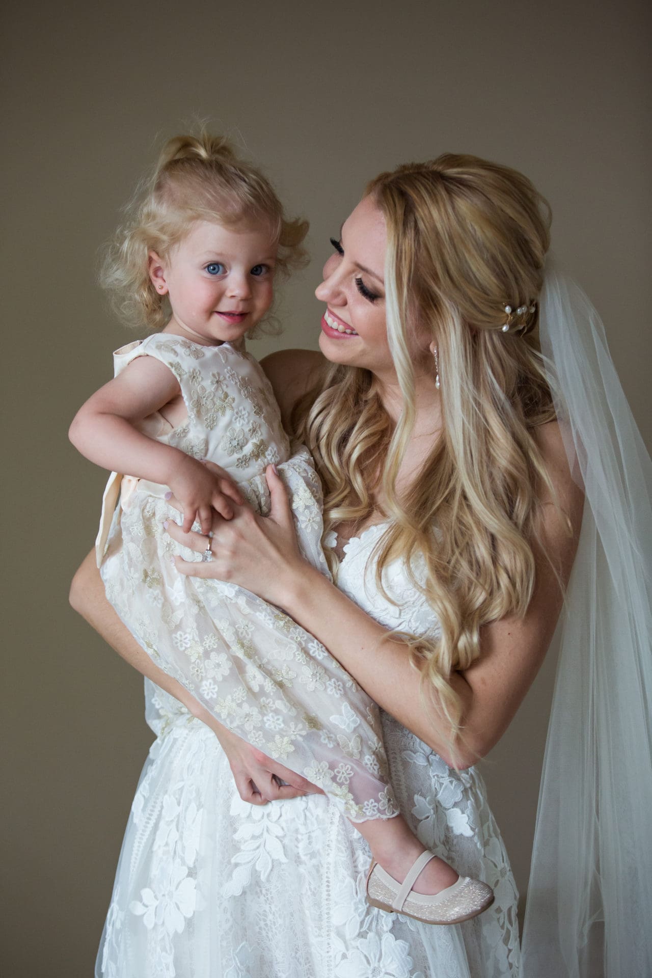 Bride with her daughter during bridal prep at her wedding