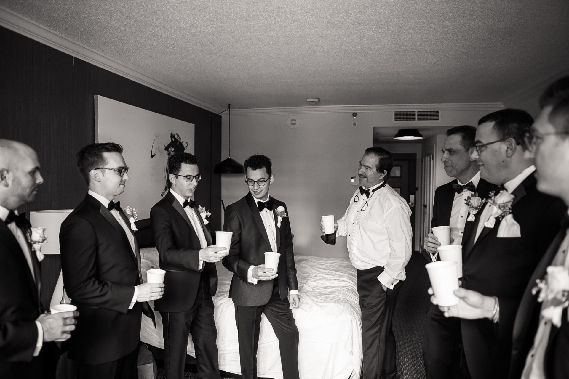 Groomsmen posing and laughing in the Logan Hotel