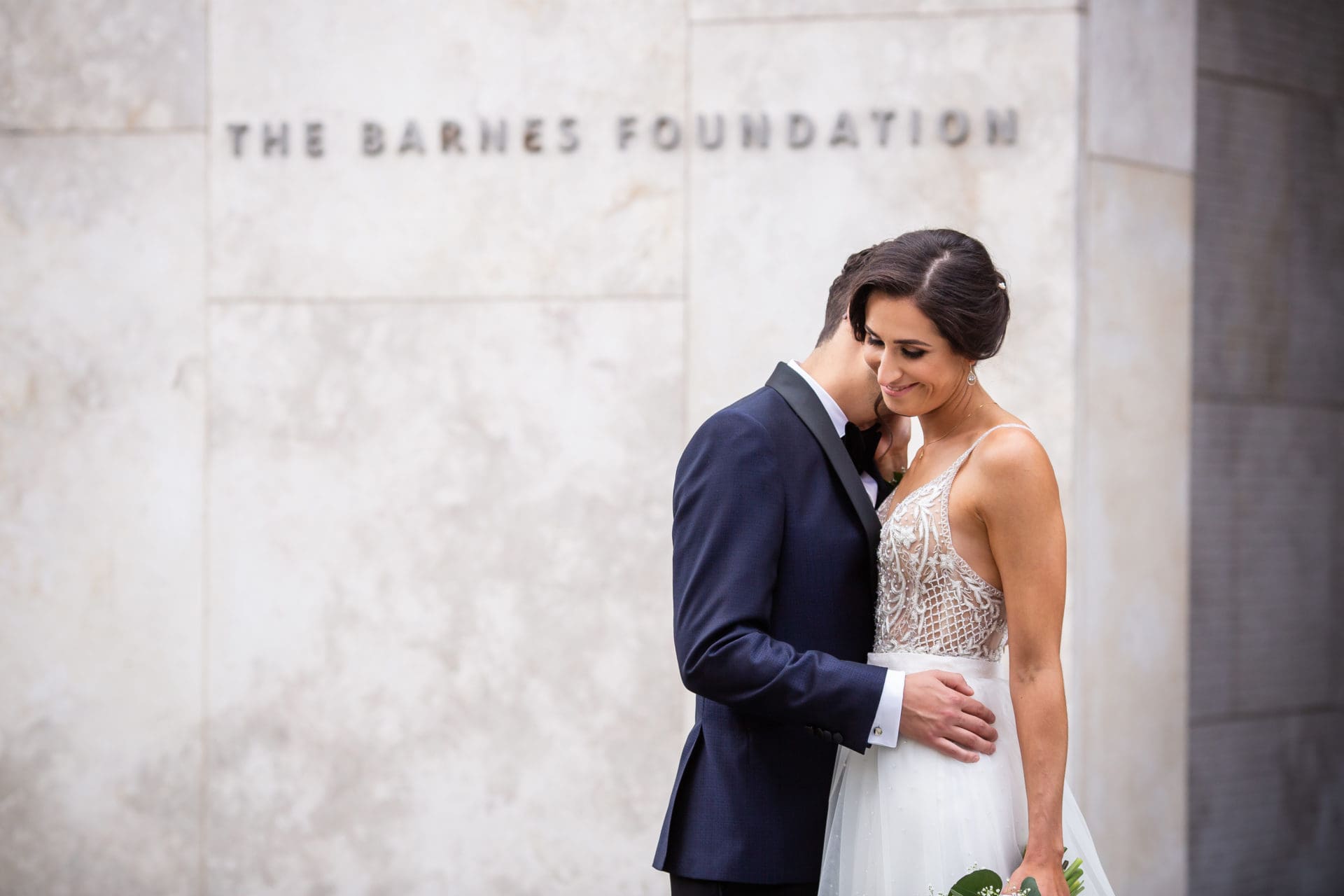 Bride and groom posing and laughing at the Barnes Foundation in Phiiladelphia