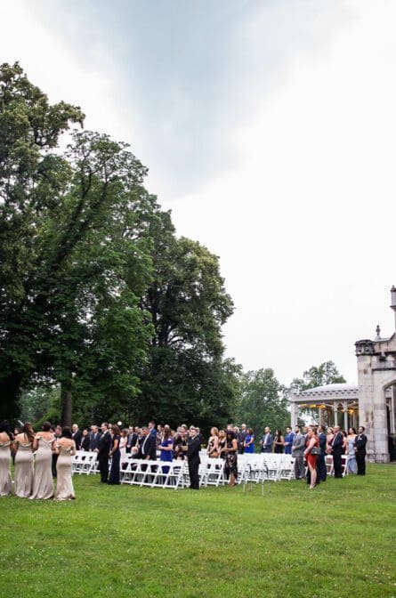 An outdoor wedding ceremony taking place on the grounds of Lyndhurst Castle in Tarrytown New York