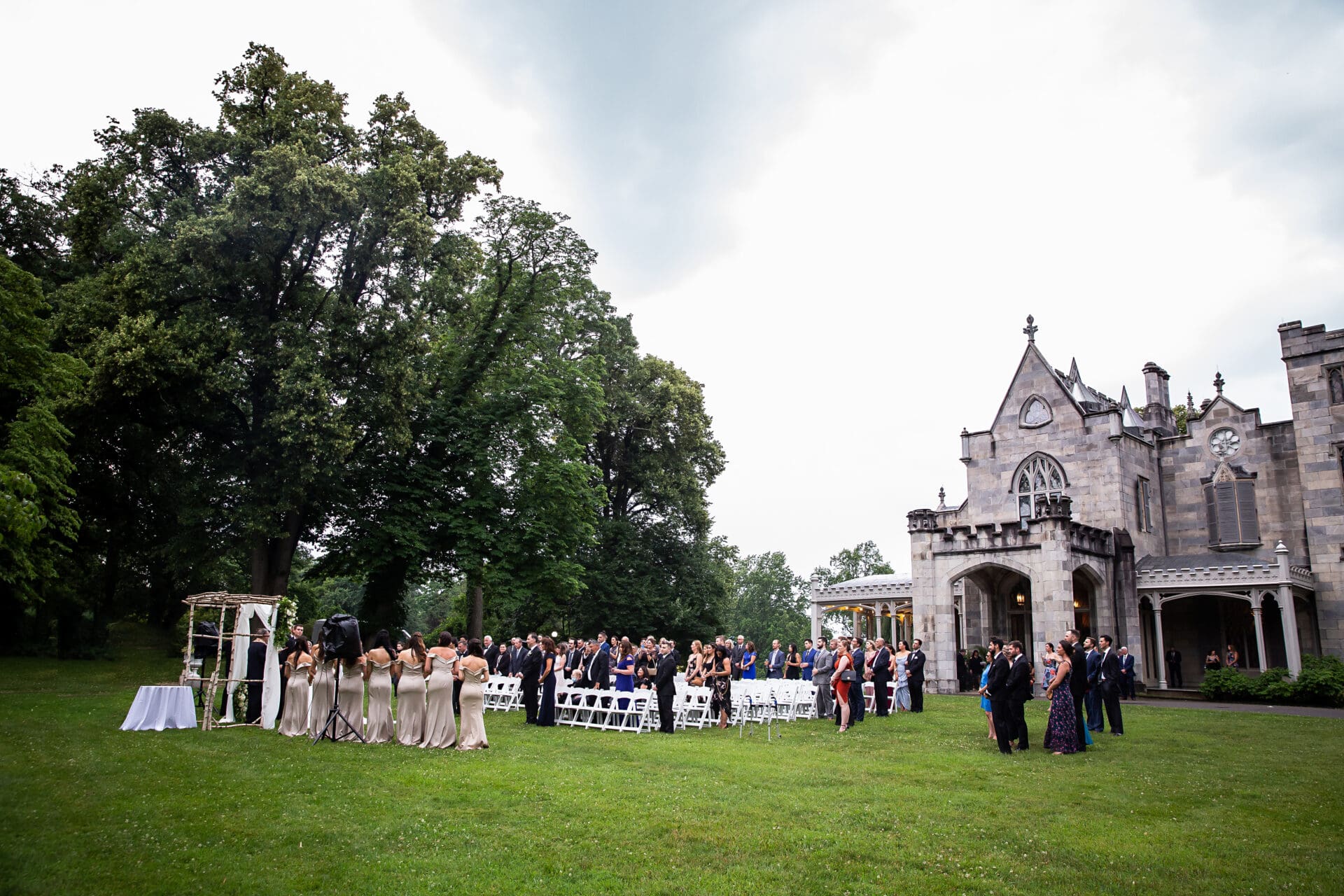 An outdoor wedding ceremony taking place on the grounds of Lyndhurst Castle in Tarrytown New York