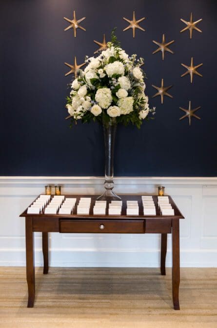 A card table and wedding decor at the entrance of a wedding at the Museum of the American Revolution