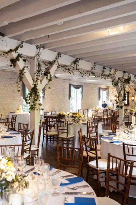 The dining room setup for a wedding reception at a NYBG Stone Mill wedding